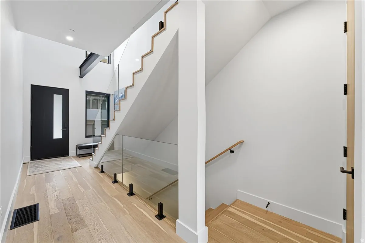 Foyer entrance featuring stairs and light wood finished floors