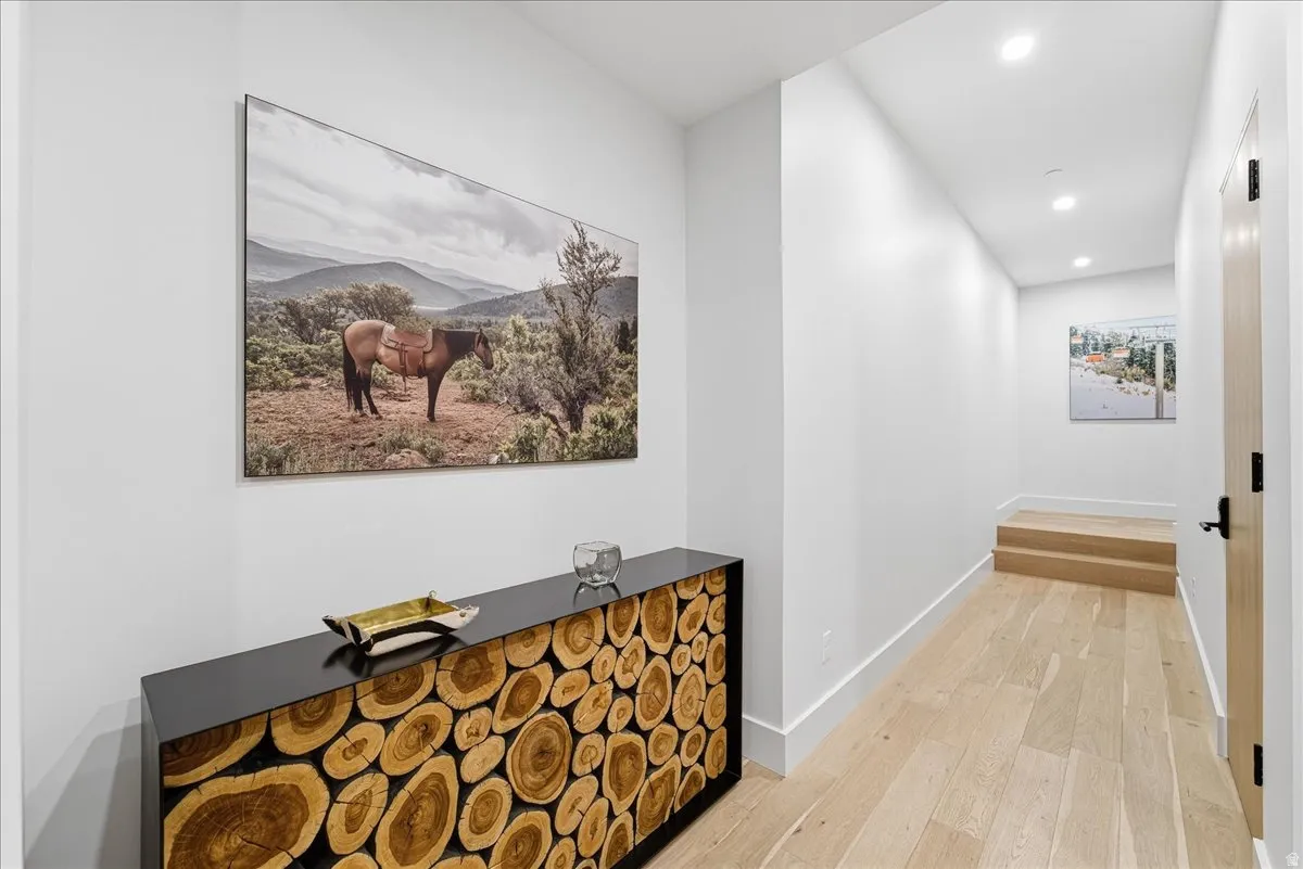 Hall featuring light wood-style floors, recessed lighting, and a mountain view