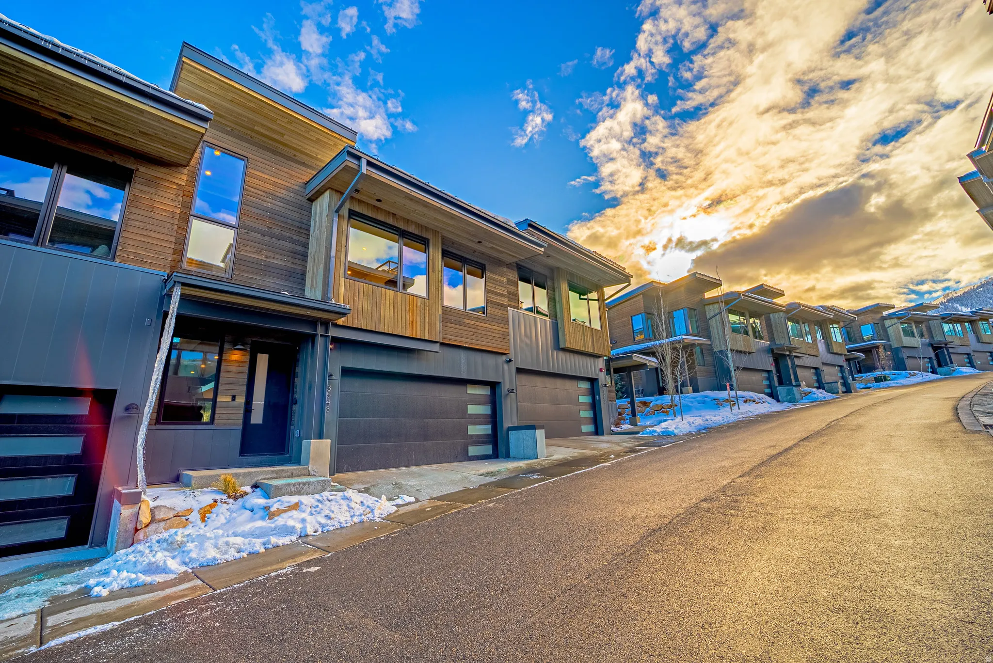 Contemporary home with an attached garage and a residential view