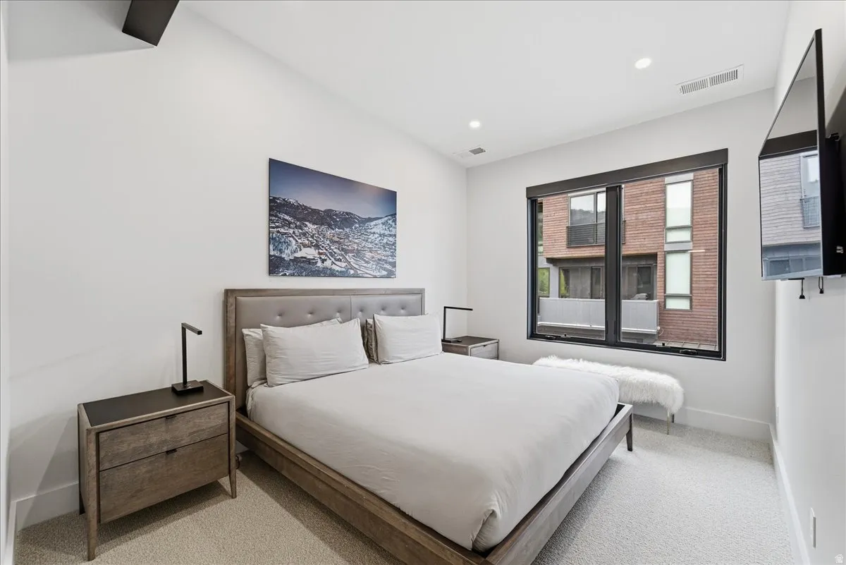 Bedroom featuring light colored carpet and recessed lighting