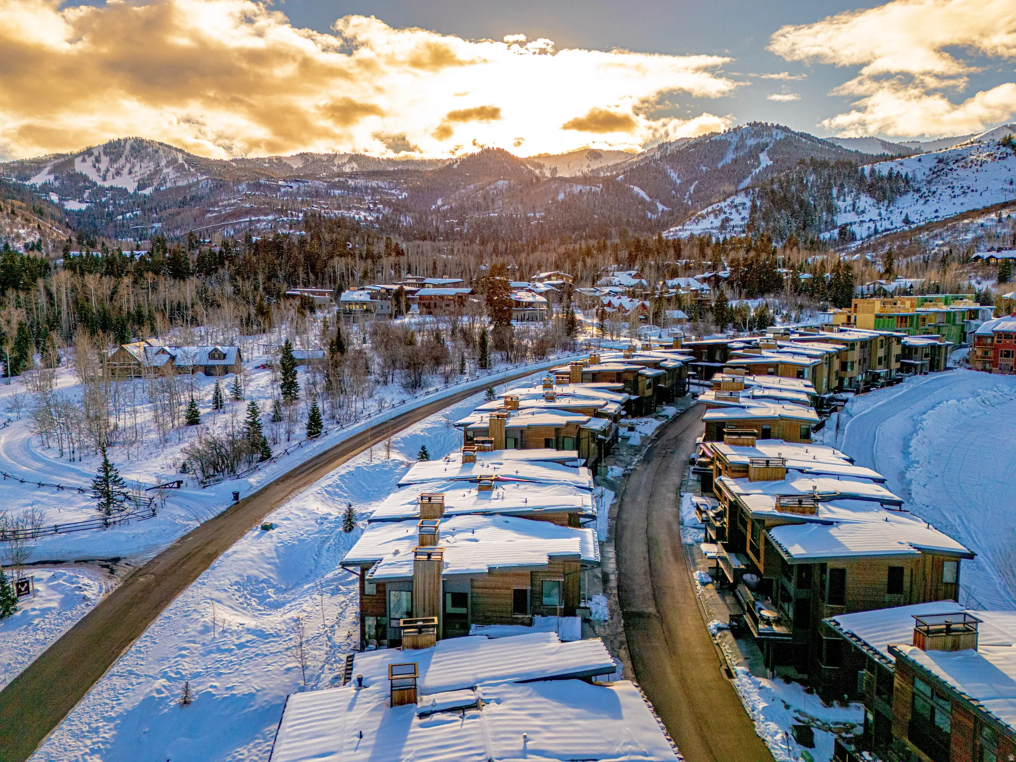 Snowy aerial view featuring a mountain view and a residential view