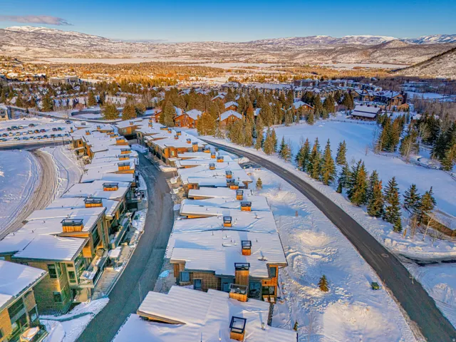 Snowy aerial view with a mountain view and a residential view