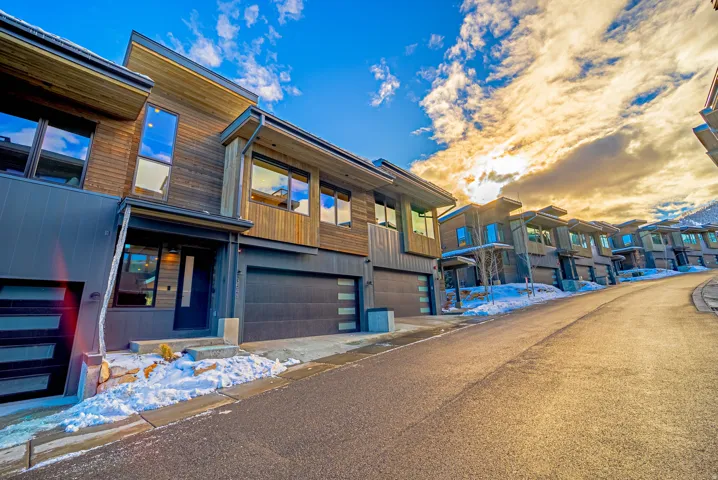 Contemporary home with an attached garage and a residential view