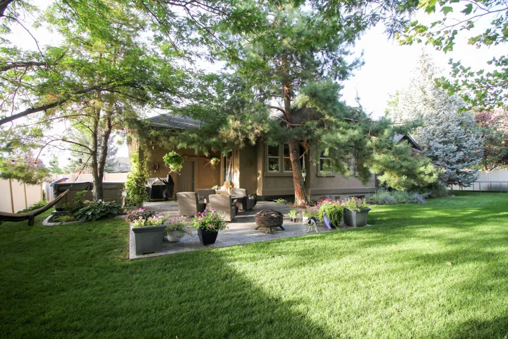Back of house featuring a patio area, an outdoor living space with a fire pit, and stucco siding