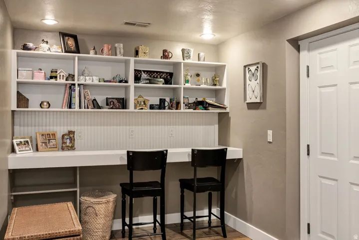 Built-in desk with overhead shelving, beadboard backing, and integrated electrical outlets