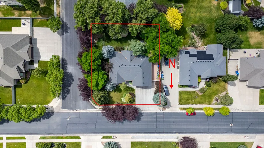 Aerial property overview featuring a substantial lot with mature landscaping