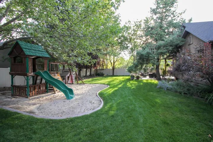 View of jungle gym with a fenced backyard