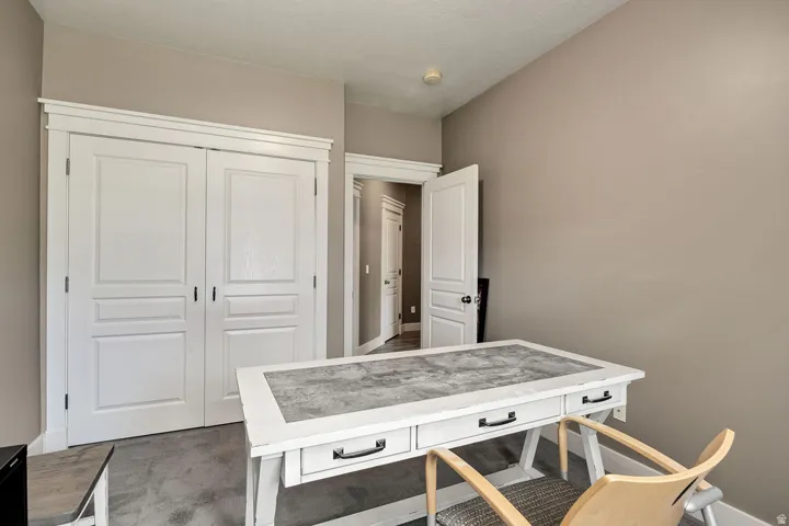 Room with neutral wall paint and plush carpet flooring