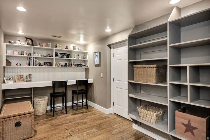 Dedicated workspace featuring built-in shelving and desk areas
