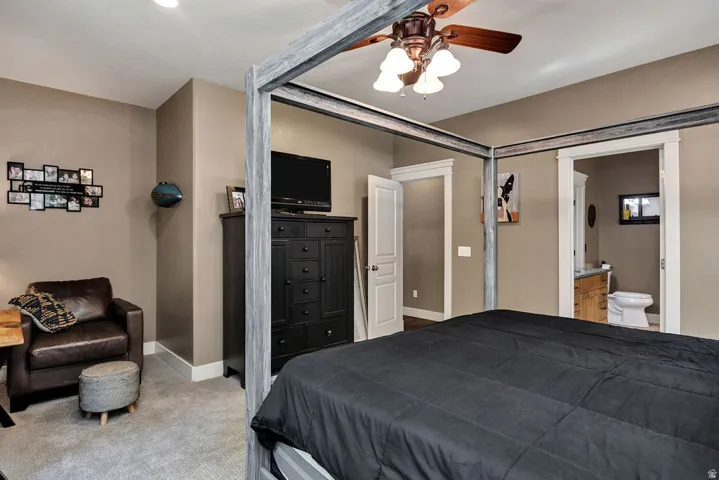 Spacious bedroom featuring neutral wall tones, recessed lighting, and a ceiling fan with integrated lighting