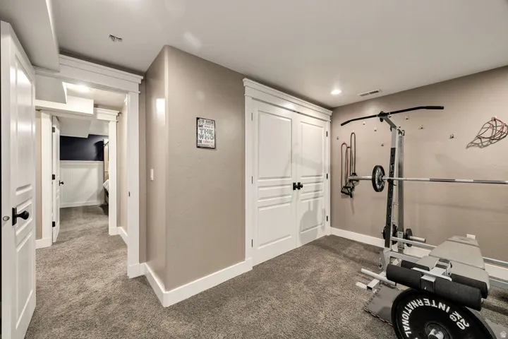 Carpeted interior space featuring neutral wall tones and recessed lighting