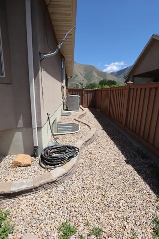 Pebble landscaping with a stone block retaining wall