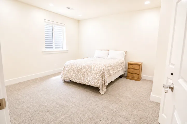 Neutral-toned carpeting paired with white baseboards and walls