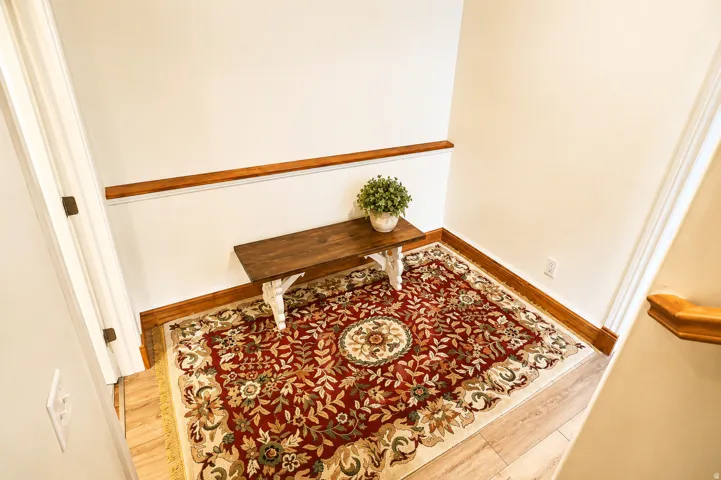 Light wood-finish flooring with wood baseboards and trim
