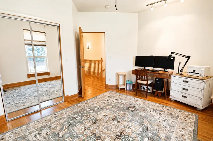 Hardwood flooring and crisp white walls provide a bright canvas