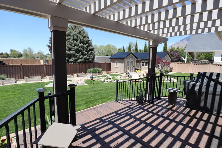 Composite deck with a white slatted pergola
