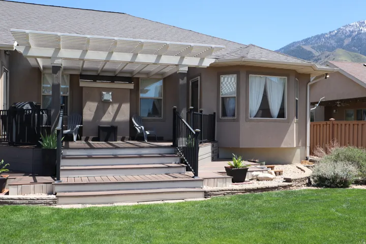 Expansive deck with multi-level wood-finish stairs and black railings