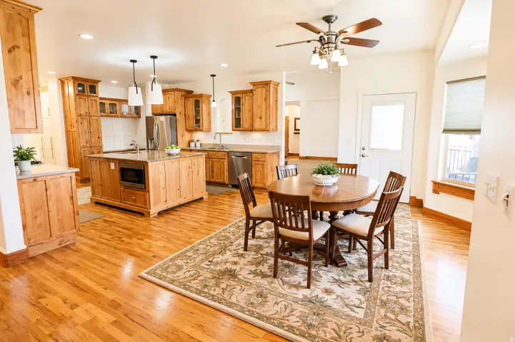 Spacious kitchen and dining area with wood-finish flooring