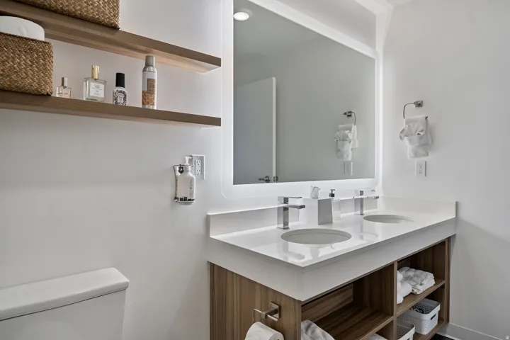 Full bathroom with double vanity and toilet