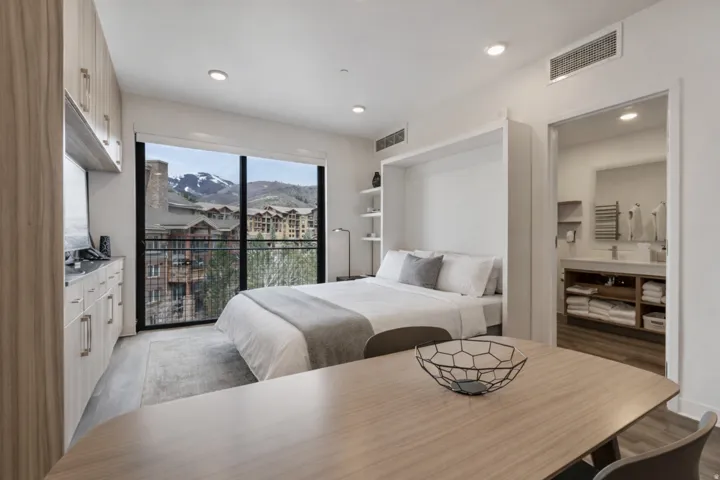 Bedroom with access to outside, light wood-style flooring, and recessed lighting