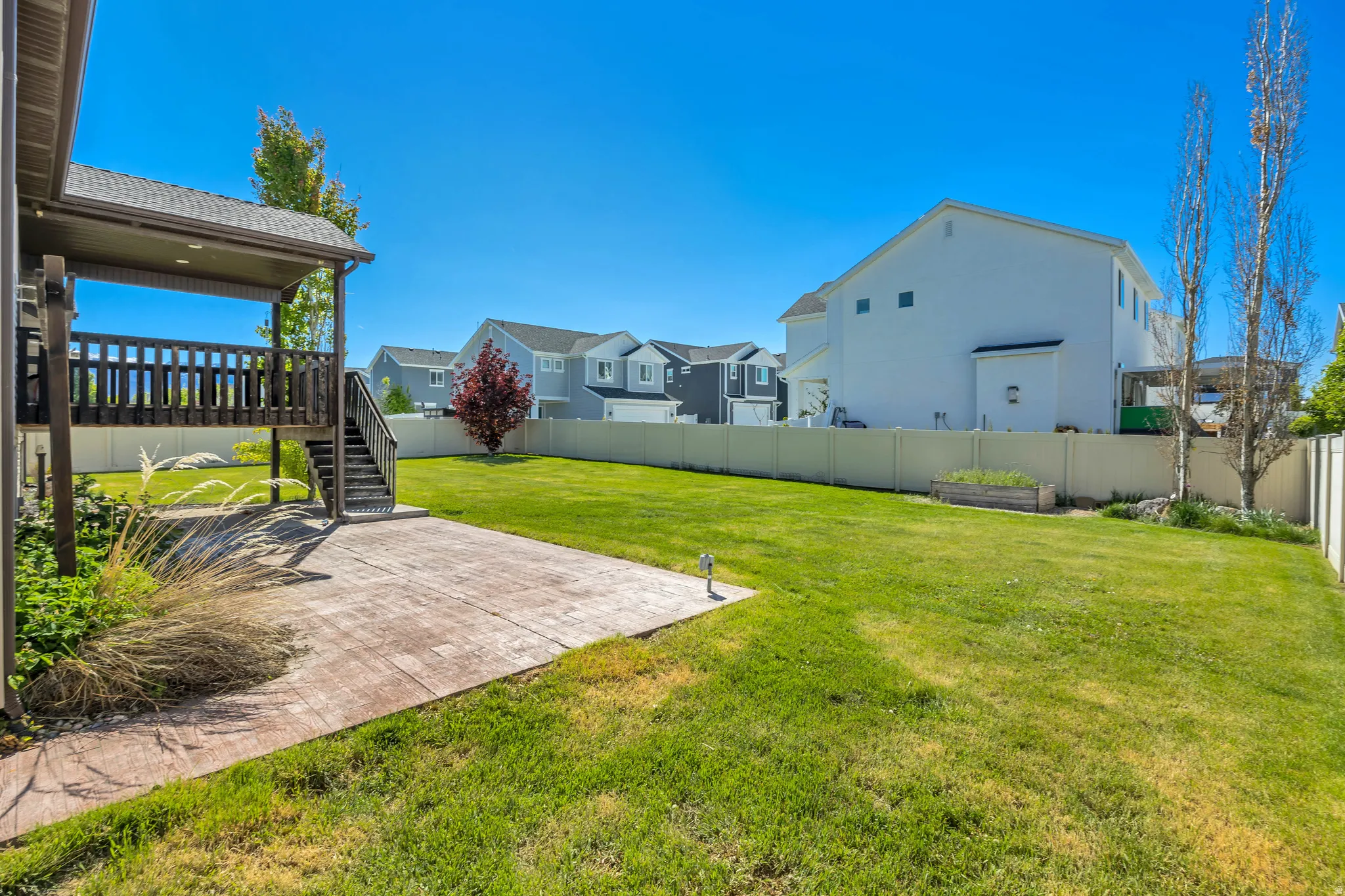Fenced backyard with a residential view and stairway