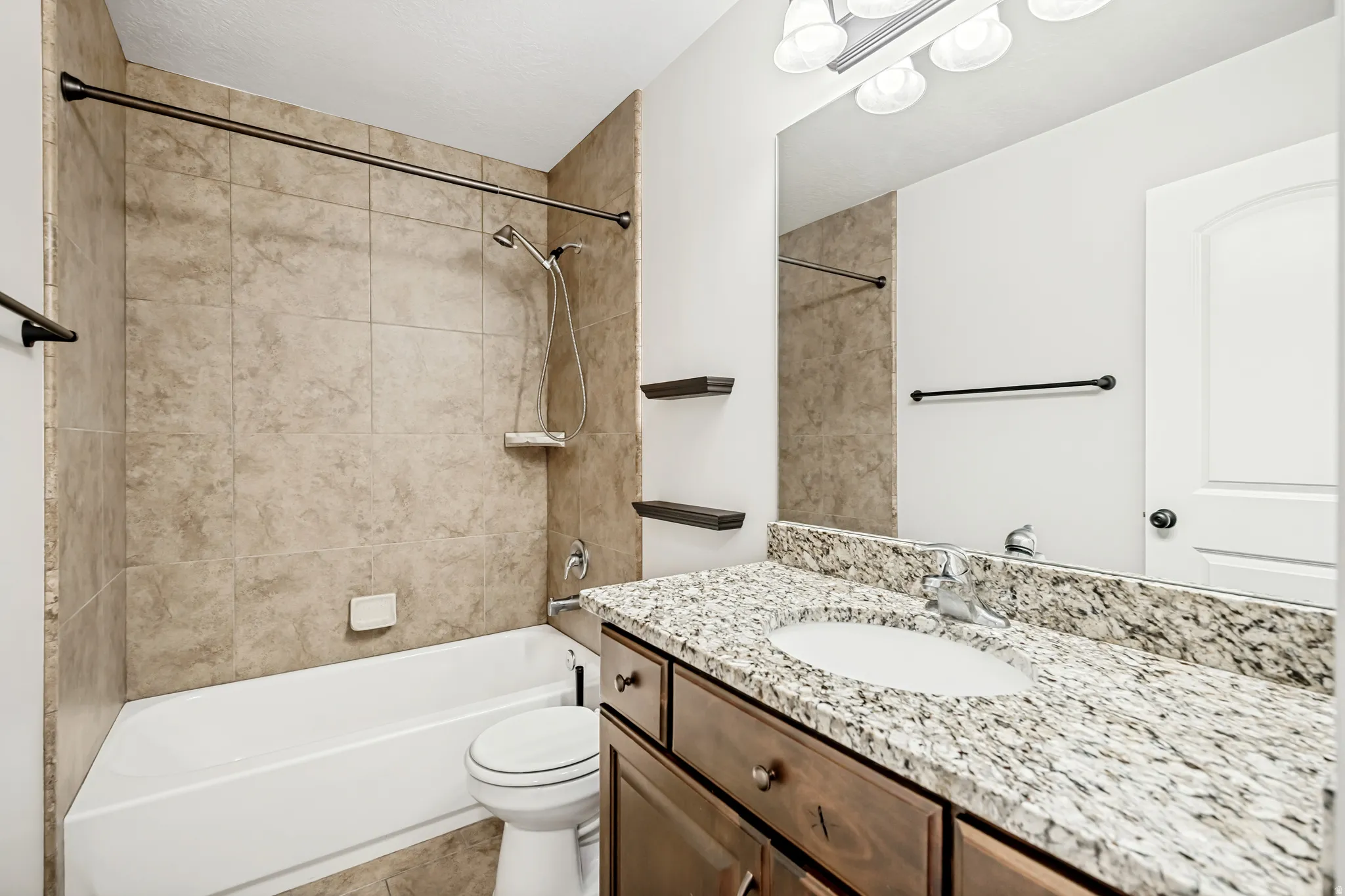 Bathroom featuring vanity and shower / bath combination