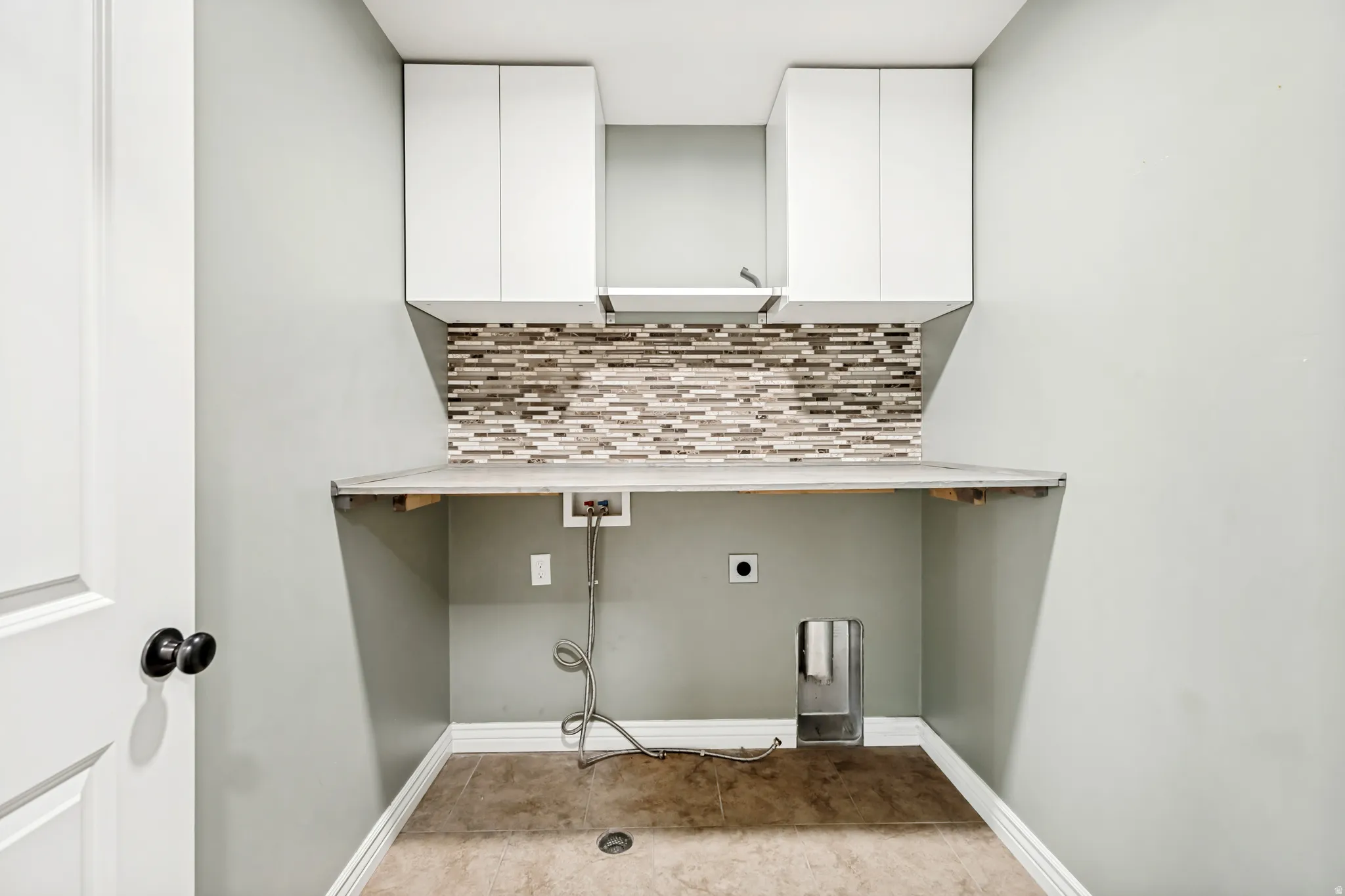 Laundry room with washer hookup, hookup for an electric dryer, and cabinet space