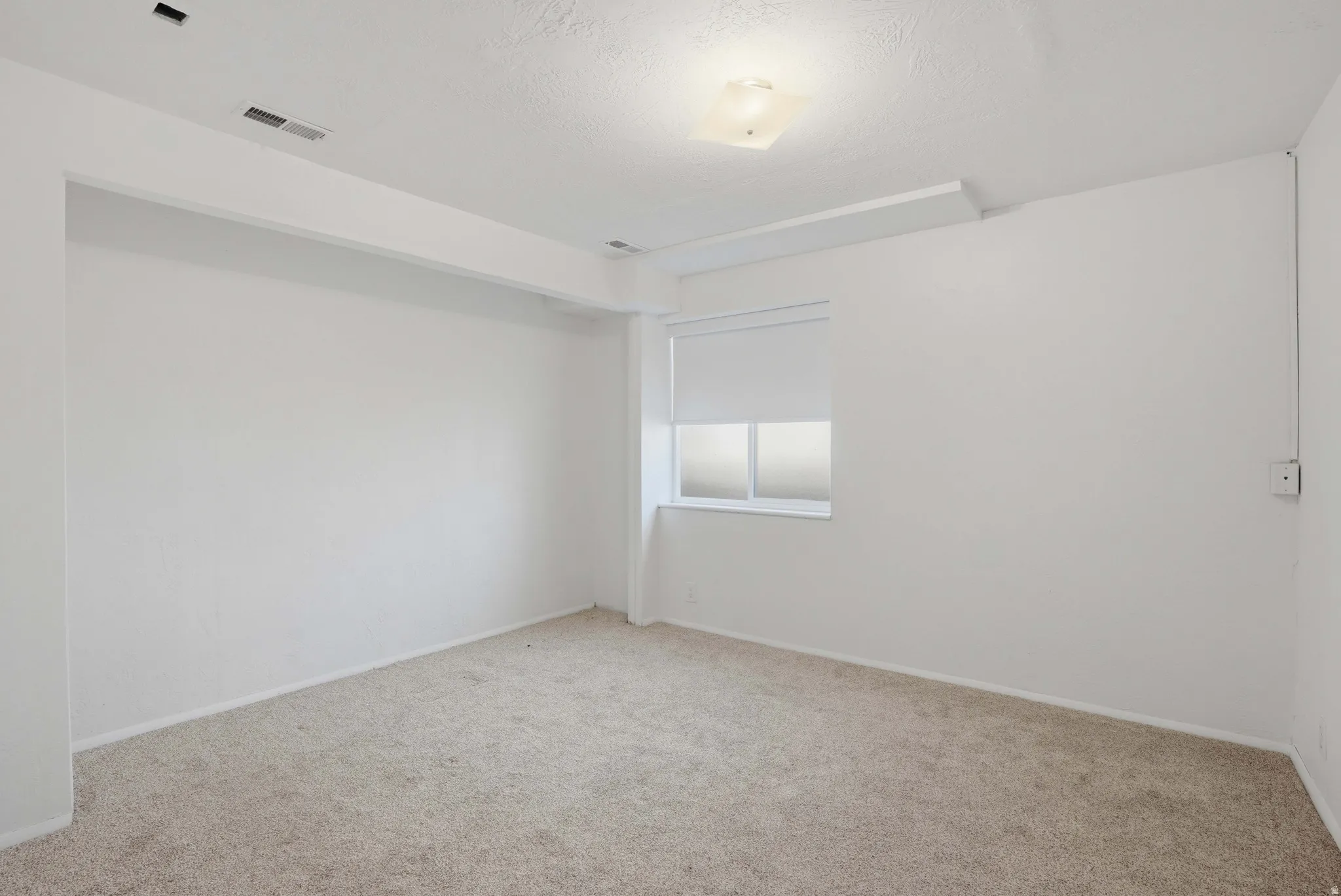 Unfurnished room featuring carpet floors and baseboards