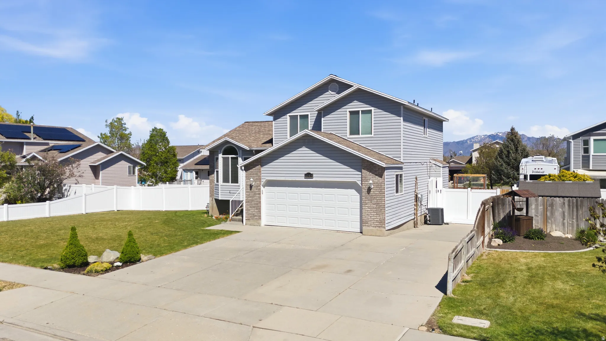View of front of property with concrete driveway, a residential view, and brick siding