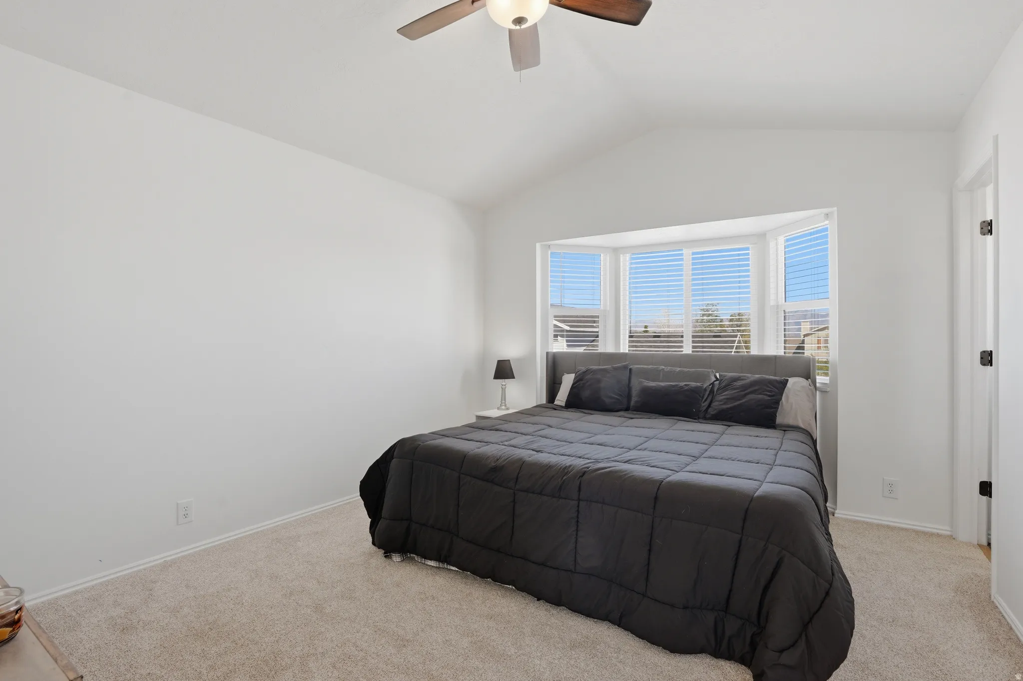 Bedroom featuring light colored carpet and a ceiling fan