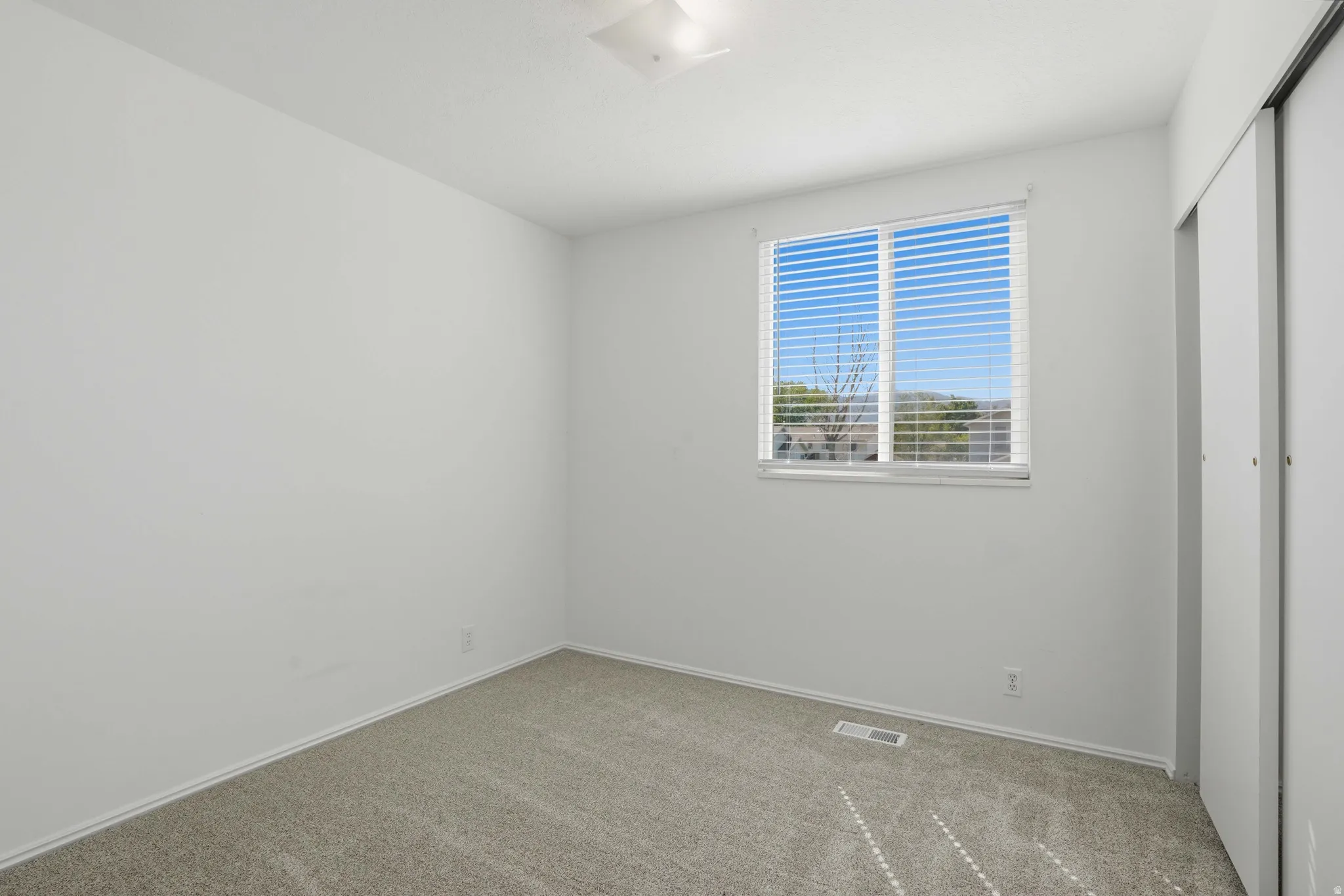Unfurnished bedroom featuring a closet and carpet floors