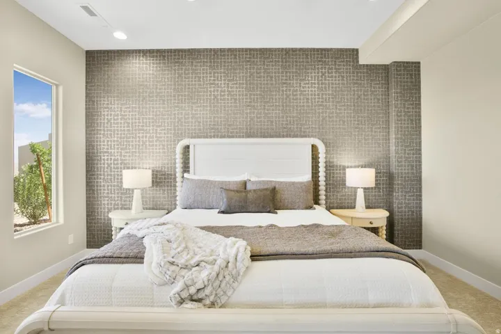 Bedroom featuring light colored carpet, an accent wall, recessed lighting, and tile walls