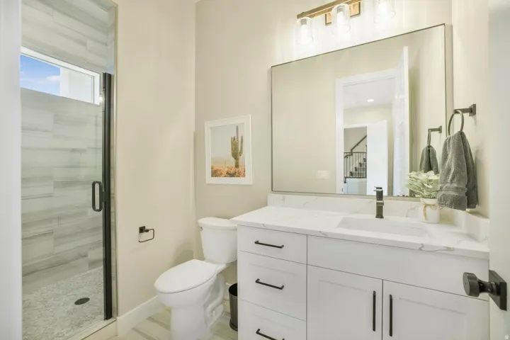Full bathroom with vanity and a stall shower