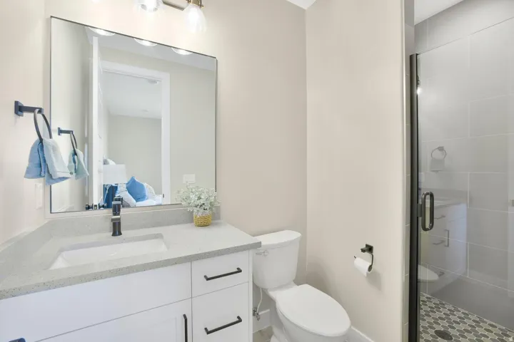 Bathroom with a stall shower, vanity, and ensuite bath