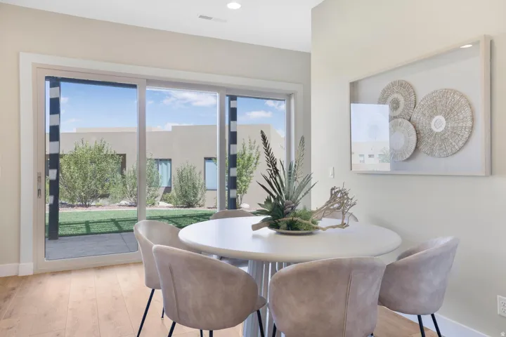 Dining space with light wood-style floors and recessed lighting