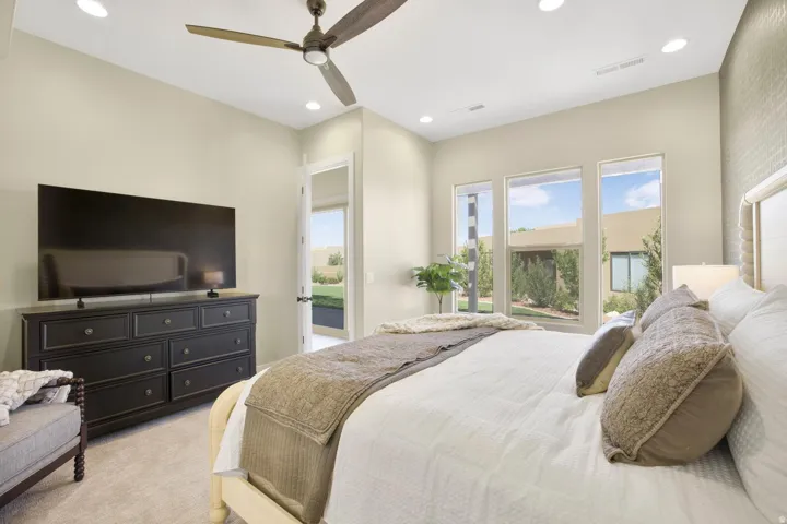Bedroom featuring access to exterior, light carpet, recessed lighting, and ceiling fan