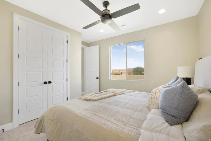 Carpeted bedroom featuring a closet, recessed lighting, and a ceiling fan