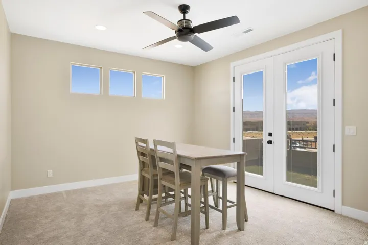 Dining room featuring french doors, light colored carpet, a ceiling fan, and recessed lighting