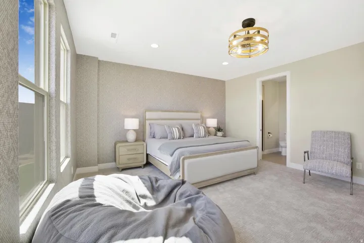 Carpeted bedroom featuring wallpapered walls, recessed lighting, ensuite bathroom, and an accent wall