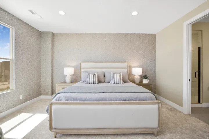 Bedroom with light carpet, recessed lighting, ensuite bath, and wallpapered walls