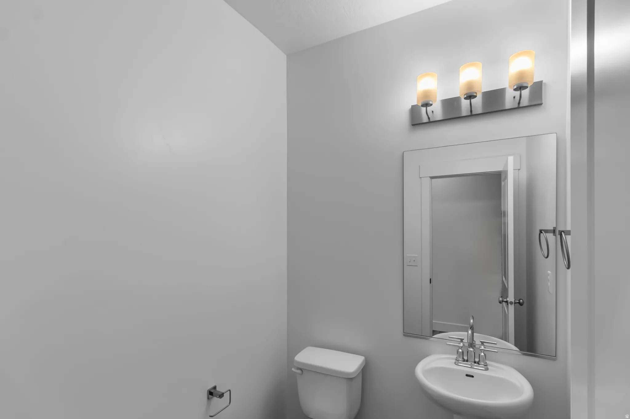 Half bath with toilet and a sink