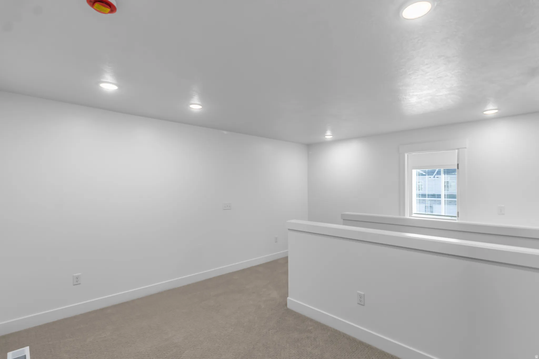 Carpeted spare room with recessed lighting