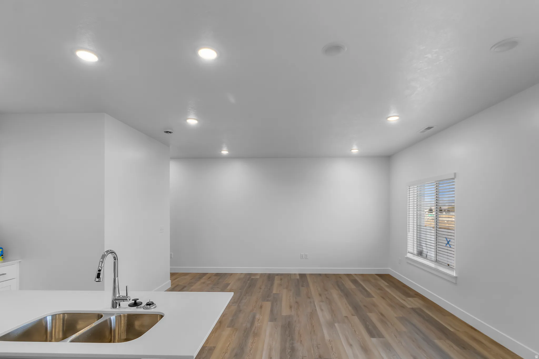 Kitchen with dark wood-style floors and recessed lighting