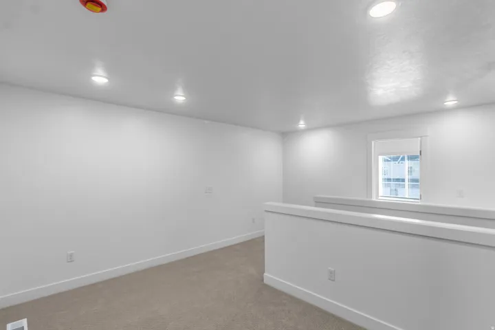 Carpeted spare room with recessed lighting
