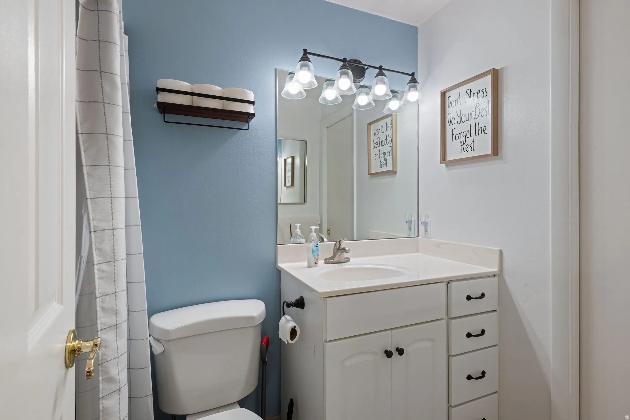 Full bathroom with vanity and curtained shower
