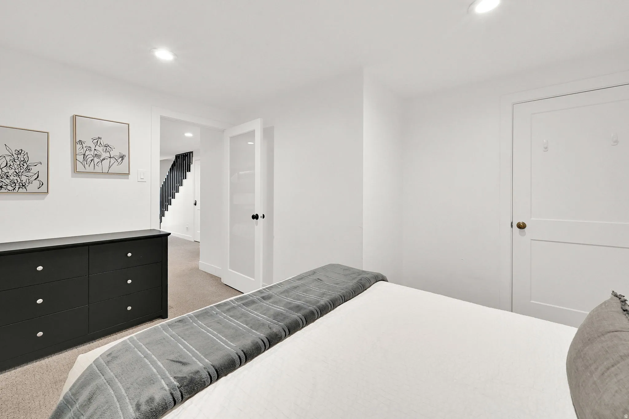 Bedroom #2 with carpet and modern finishes, the door is frosted glass.