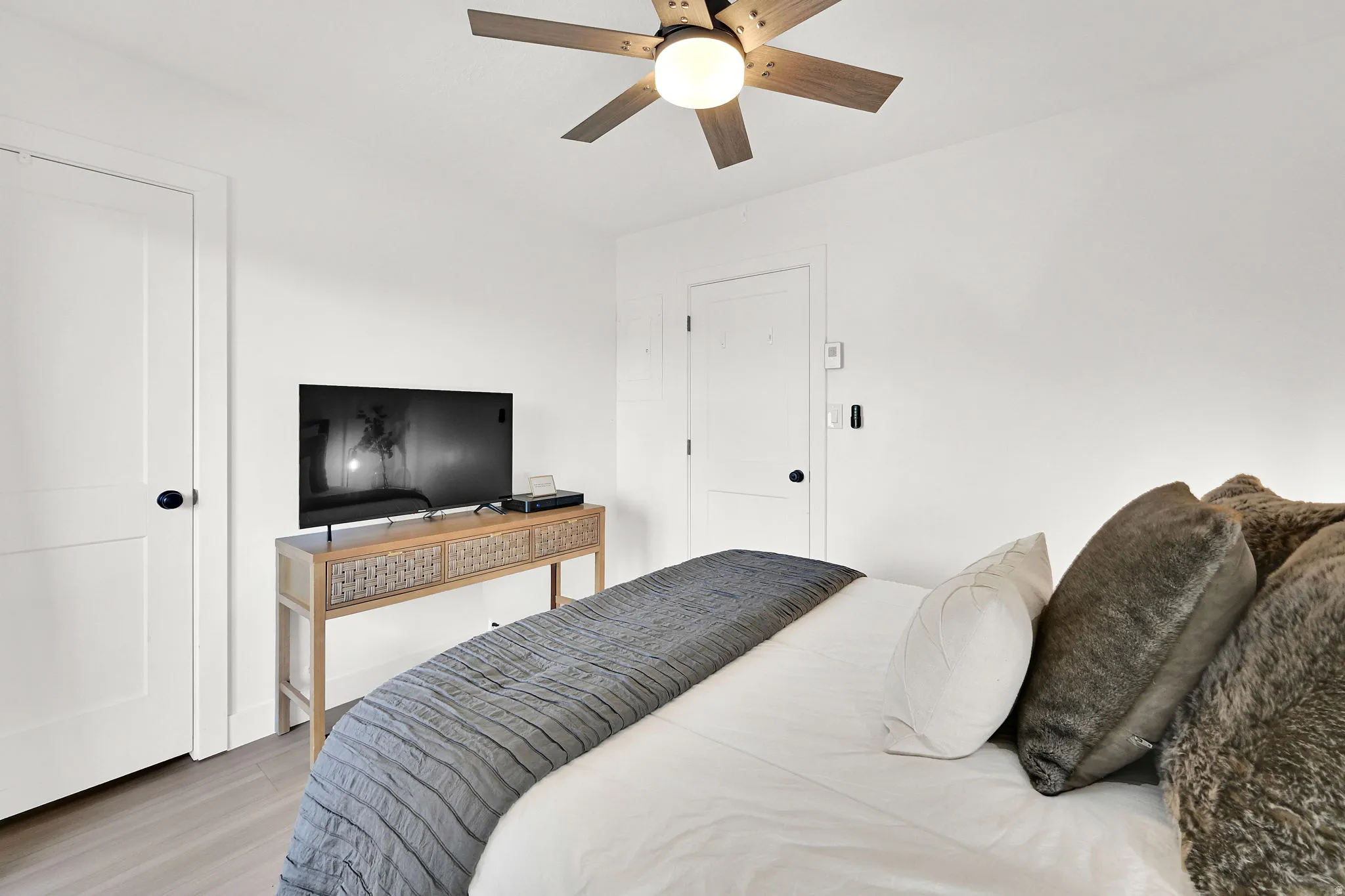 Main floor bedroom #1 with LVP flooring and a private deck.