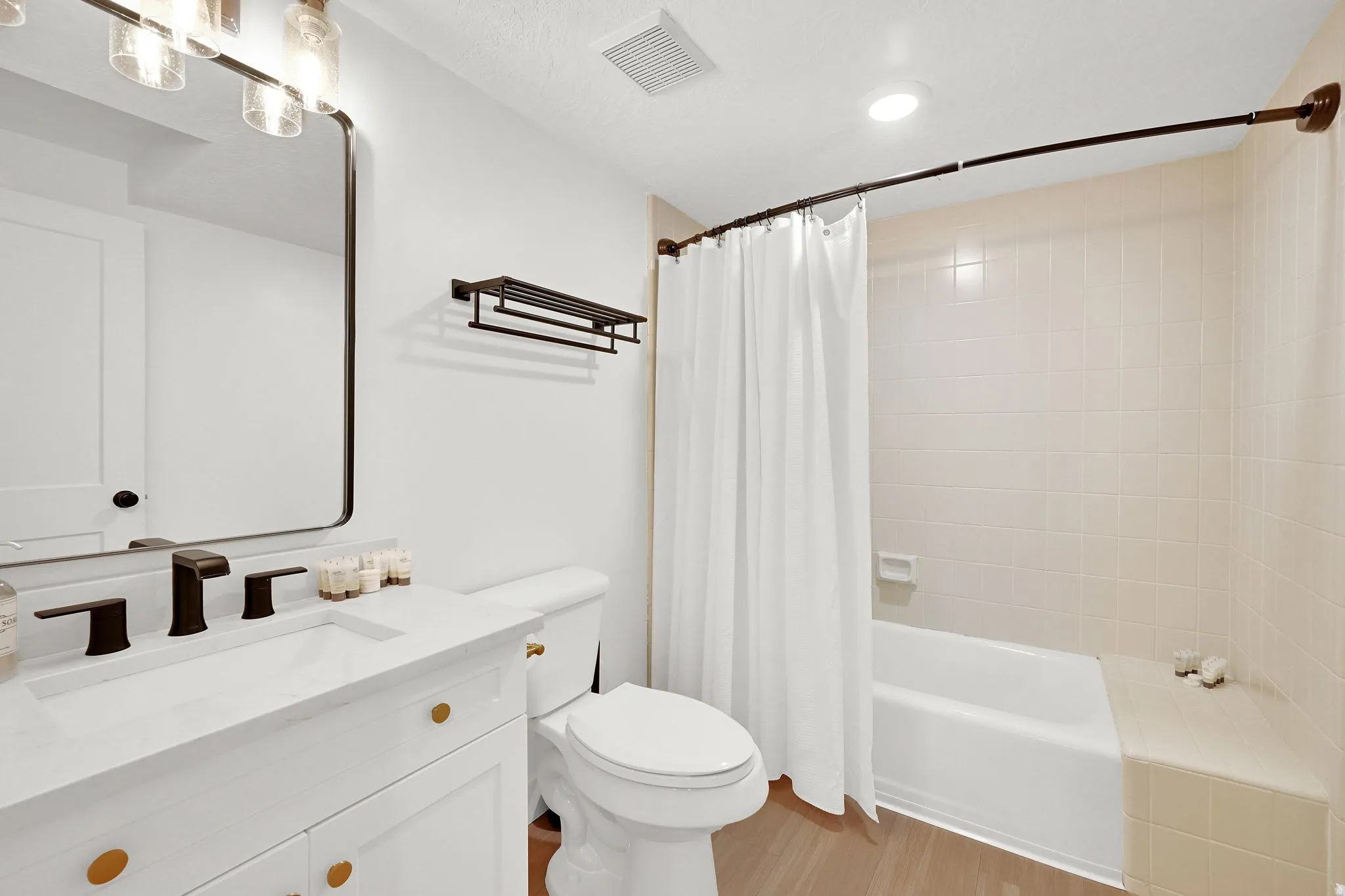 Downstairs full bathroom with tile surround and new vanity.