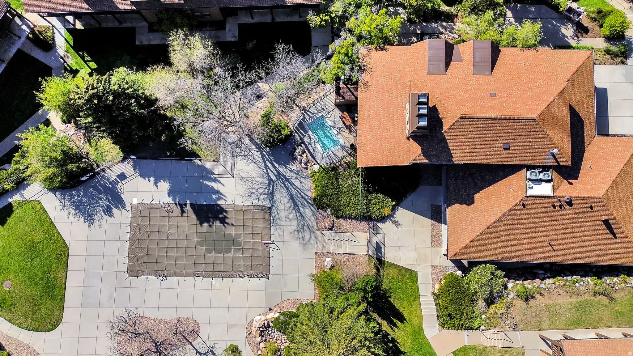 Aerial view of the community clubhouse and pool with separate hot tub