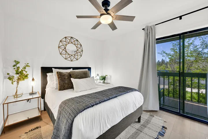 Main floor bedroom #1 with LVP flooring and a private deck.
